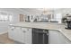Kitchen with breakfast bar featuring stainless steel dishwasher and white cabinetry at 4887 Luster Leaf Circle # 105, Myrtle Beach, SC 29577