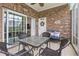 Cozy enclosed brick patio with seating and decorative elements at 4887 Luster Leaf Circle # 105, Myrtle Beach, SC 29577