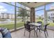 Enclosed patio with tiled flooring and a lovely view of the pond and surrounding landscaping at 4887 Luster Leaf Circle # 105, Myrtle Beach, SC 29577