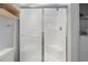 Enclosed shower with sliding glass doors and built in shelves for added convenience at 4887 Luster Leaf Circle # 105, Myrtle Beach, SC 29577