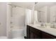 Clean bathroom with a shower-tub combo, a dark wood vanity and a large mirror with a white countertop at 4925 Pond Shoals Ct. # 202, Myrtle Beach, SC 29579