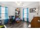 Bright bedroom with a ceiling fan, hardwood floors, and plenty of space for a home office at 4925 Pond Shoals Ct. # 202, Myrtle Beach, SC 29579