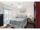 Inviting bedroom with a plush bed, natural light, and tasteful decor for relaxation at 4925 Pond Shoals Ct. # 202, Myrtle Beach, SC 29579