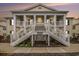 Inviting two-story condo featuring double staircases and a charming covered porch at 4925 Pond Shoals Ct. # 202, Myrtle Beach, SC 29579