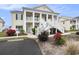 Inviting two-story condo with double staircases, mature landscaping, and reserved parking at 4925 Pond Shoals Ct. # 202, Myrtle Beach, SC 29579