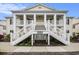 Inviting exterior showcasing symmetrical staircases and covered porches, creating a grand entrance and curb appeal at 4925 Pond Shoals Ct. # 202, Myrtle Beach, SC 29579