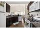 Well-equipped kitchen with dark cabinets, stainless appliances, and open dining area at 4925 Pond Shoals Ct. # 202, Myrtle Beach, SC 29579