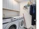 Bright laundry room with white cabinets, Samsung washer and dryer, and a convenient hanging rack for clothes at 4925 Pond Shoals Ct. # 202, Myrtle Beach, SC 29579