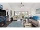 Comfortable living room with a cozy fireplace and access to the outdoor patio at 4925 Pond Shoals Ct. # 202, Myrtle Beach, SC 29579
