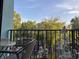 Balcony with seating overlooks a lush, green landscape and parking area at 5001 Little River Rd. # E-306, Myrtle Beach, SC 29577