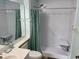 Bright bathroom featuring a roll-in shower with grab bars and built in seat at 5001 Little River Rd. # E-306, Myrtle Beach, SC 29577