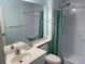 Bright bathroom featuring a roll-in shower with grab bars and built in seat at 5001 Little River Rd. # E-306, Myrtle Beach, SC 29577