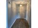Hallway features wood-look flooring, neutral paint, a coat closet and a light fixture at 5001 Little River Rd. # E-306, Myrtle Beach, SC 29577