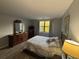 Main bedroom features wood-look flooring, a queen bed, and a window with natural light at 5001 Little River Rd. # E-306, Myrtle Beach, SC 29577