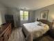 Main bedroom featuring wood-look flooring, a queen bed, and large window at 5001 Little River Rd. # E-306, Myrtle Beach, SC 29577