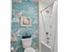 Bathroom with blue wave wallpaper, a toilet, a shower, and a decorative picture frame at 5068 Wavering Place Loop, Myrtle Beach, SC 29579