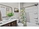 Bathroom featuring a shower/tub combo and vanity with dark wood cabinets at 5068 Wavering Place Loop, Myrtle Beach, SC 29579