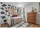 Bedroom features an accent wall, a mirror, a plush rug, and natural light at 5068 Wavering Place Loop, Myrtle Beach, SC 29579