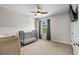 Bedroom with neutral walls, a black crib, and a window with green curtains at 5068 Wavering Place Loop, Myrtle Beach, SC 29579