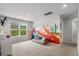 Spacious bonus room with a mural, basketball hoop, comfortable seating, and bright natural light at 5068 Wavering Place Loop, Myrtle Beach, SC 29579
