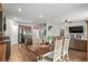 Bright dining room with hardwood floors, and a view of the open concept kitchen and living areas at 5068 Wavering Place Loop, Myrtle Beach, SC 29579