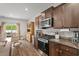 Modern kitchen boasts stainless steel appliances, granite countertops, and plenty of storage space, blending style and functionality at 5068 Wavering Place Loop, Myrtle Beach, SC 29579