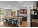 Well-equipped kitchen boasts stainless steel appliances, a functional island, and ample counter space for cooking at 5068 Wavering Place Loop, Myrtle Beach, SC 29579