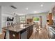 Open concept living area with a granite kitchen island and hardwood flooring throughout the space at 5068 Wavering Place Loop, Myrtle Beach, SC 29579