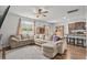 Living room with a sectional sofa, hardwood floors, and a view of the dining area and kitchen at 5068 Wavering Place Loop, Myrtle Beach, SC 29579