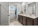 Main bathroom featuring double sinks, tile flooring, and a walk-in closet at 5068 Wavering Place Loop, Myrtle Beach, SC 29579