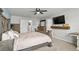 Main bedroom features a TV, wooden furniture, and carpeted floors at 5068 Wavering Place Loop, Myrtle Beach, SC 29579