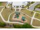 Aerial view of the community playground with multiple slides and play structures surrounded by a black metal safety fence at 5068 Wavering Place Loop, Myrtle Beach, SC 29579