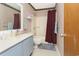 Bathroom featuring a vanity with powder-blue cabinets, a shower, and vertically striped wallpaper at 510 Fairwood Lakes Dr. # 17-P, Myrtle Beach, SC 29588