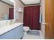 Cozy bathroom featuring a vanity with powder-blue cabinets and a shower with a maroon shower curtain at 510 Fairwood Lakes Dr. # 17-P, Myrtle Beach, SC 29588