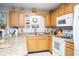 Well-lit kitchen with practical layout, featuring wood cabinets and white appliances at 510 Fairwood Lakes Dr. # 17-P, Myrtle Beach, SC 29588