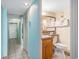 Bathroom boasts a wooden vanity, toilet, and large mirror with towels, next to the hallway at 5511 North Ocean Blvd. # 806, Myrtle Beach, SC 29577