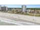 Expansive view of a sunny beachside property showcasing several buildings and a sandy beach at 5511 North Ocean Blvd. # 806, Myrtle Beach, SC 29577