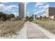 Beautiful resort featuring a boardwalk, tall buildings, palm trees, and scenic views at 5511 North Ocean Blvd. # 806, Myrtle Beach, SC 29577
