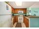 Efficient kitchen featuring wood cabinetry, white appliances, and a breakfast bar that opens to the living space at 5511 North Ocean Blvd. # 806, Myrtle Beach, SC 29577