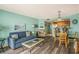 Airy living room featuring sofa, wood-look floors, and an open floor plan flowing into the kitchen at 5511 North Ocean Blvd. # 806, Myrtle Beach, SC 29577