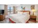 Comfortable main bedroom with large window, wood nightstands, and plush bedding at 5511 North Ocean Blvd. # 806, Myrtle Beach, SC 29577