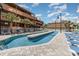 Unique pool area with a center island, surrounded by lounge chairs and palm trees at 5511 North Ocean Blvd. # 806, Myrtle Beach, SC 29577