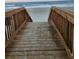 Wooden staircase leading down to a sandy beach and the ocean for convenient beach access at 5905 S Kings Hwy. # 523 A, Myrtle Beach, SC 29575