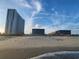 Scenic beachfront view of resort condos against a blue sky, situated along a sandy beach at 5905 S Kings Hwy. # 523 A, Myrtle Beach, SC 29575