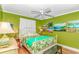 Bright bedroom featuring a leafy green color scheme and beach-themed artwork at 5905 S Kings Hwy. # 523 A, Myrtle Beach, SC 29575