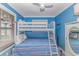 This cozy bedroom has a bunk bed with blue striped bedding and white trimmings at 5905 S Kings Hwy. # 523 A, Myrtle Beach, SC 29575