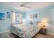 Comfortable bedroom with coastal decor, a ceiling fan, and a large window at 6000 N Ocean Blvd. # 133, North Myrtle Beach, SC 29582