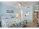 Inviting bedroom with a bed, soft blue walls, and a peek into the kitchen at 6000 N Ocean Blvd. # 133, North Myrtle Beach, SC 29582