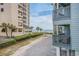Beachfront access between condo buildings, views of the ocean and palm trees at 6000 N Ocean Blvd. # 133, North Myrtle Beach, SC 29582