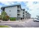 Coastal condo building featuring multiple floors with private balconies and ample parking space at 6000 N Ocean Blvd. # 133, North Myrtle Beach, SC 29582